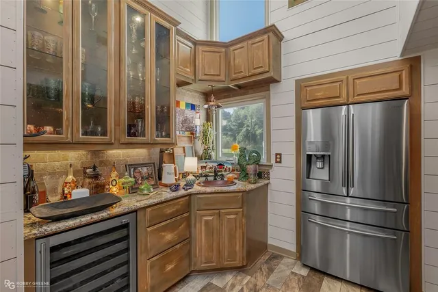 a kitchen with stainless steel appliances a refrigerator and a sink