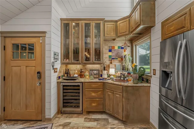 a kitchen with stainless steel appliances granite countertop a refrigerator and a stove