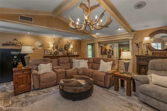 a living room with furniture and a chandelier