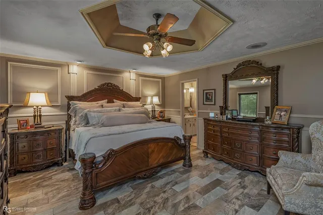 a bedroom with a bed and ceiling fan