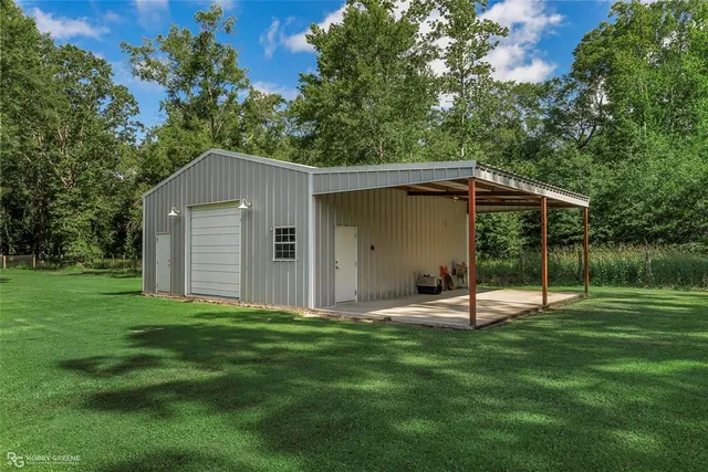 a backyard of a house with table and chairs