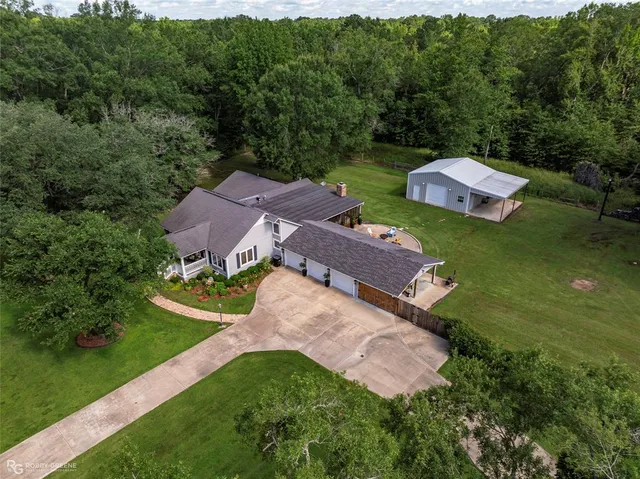 an aerial view of a house with garden space and a street view
