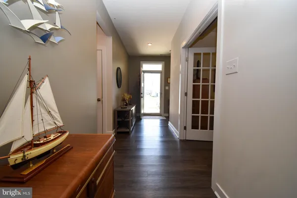 a view of a hallway with wooden floor