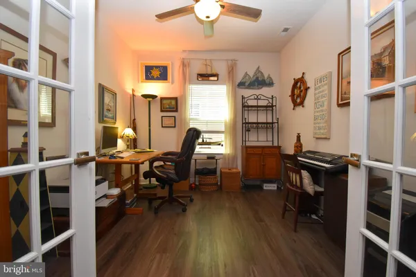 a view of a workspace with furniture and wooden floor