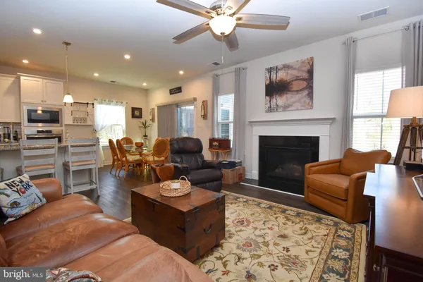 a living room with furniture fireplace and window