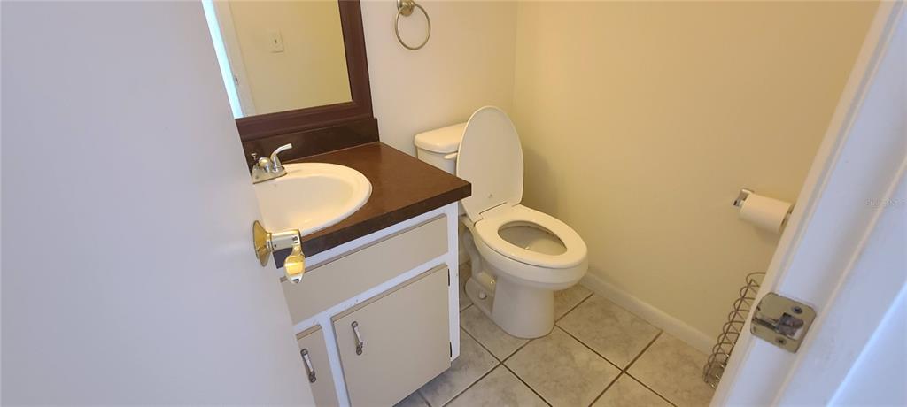 2114 Northeast 38th Terrace Ocala, FL 34470 - Photo 7 of 8 a bathroom with a toilet and a mirror