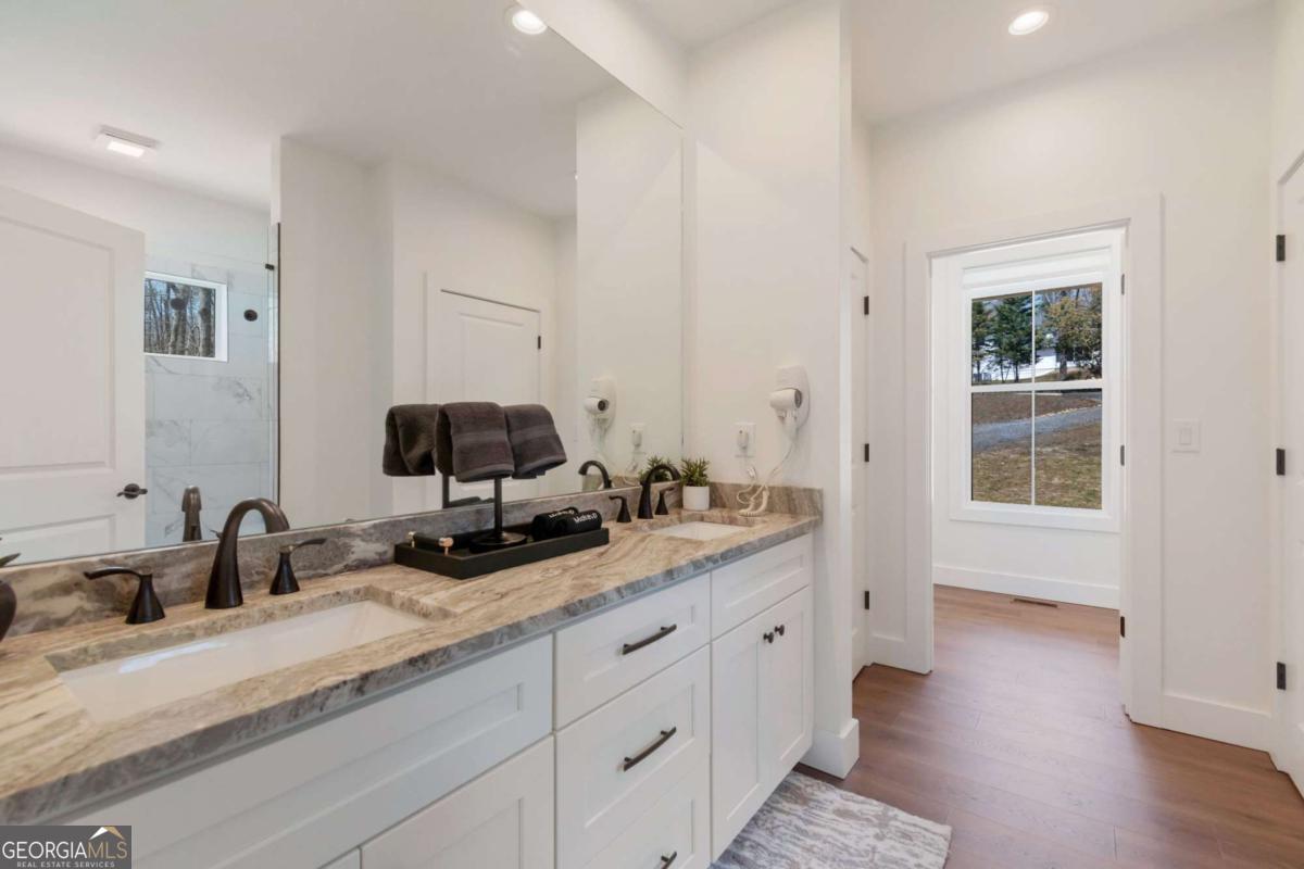 629 Butterworth Road Canton, GA 30114 - Photo 13 of 27 a en suite bathroom with a granite countertop double vanity sink