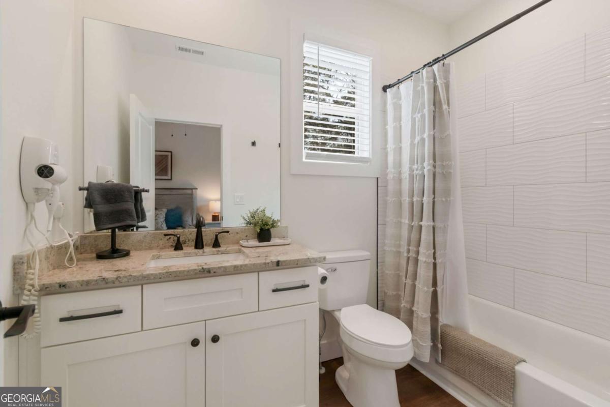 629 Butterworth Road Canton, GA 30114 - Photo 19 of 27 a bathroom with a granite countertop toilet sink and mirror