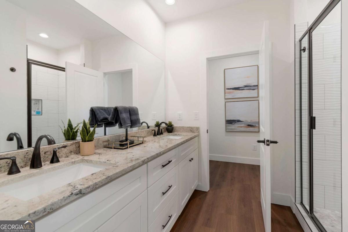 629 Butterworth Road Canton, GA 30114 - Photo 22 of 27 a bathroom with a double vanity sink and mirror