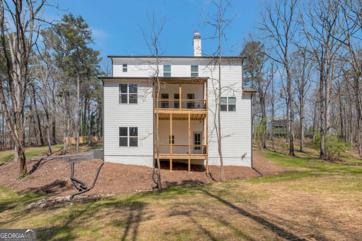 629 Butterworth Road Canton, GA 30114 - Photo 25 of 27 a view of a house with backyard porch and sitting area