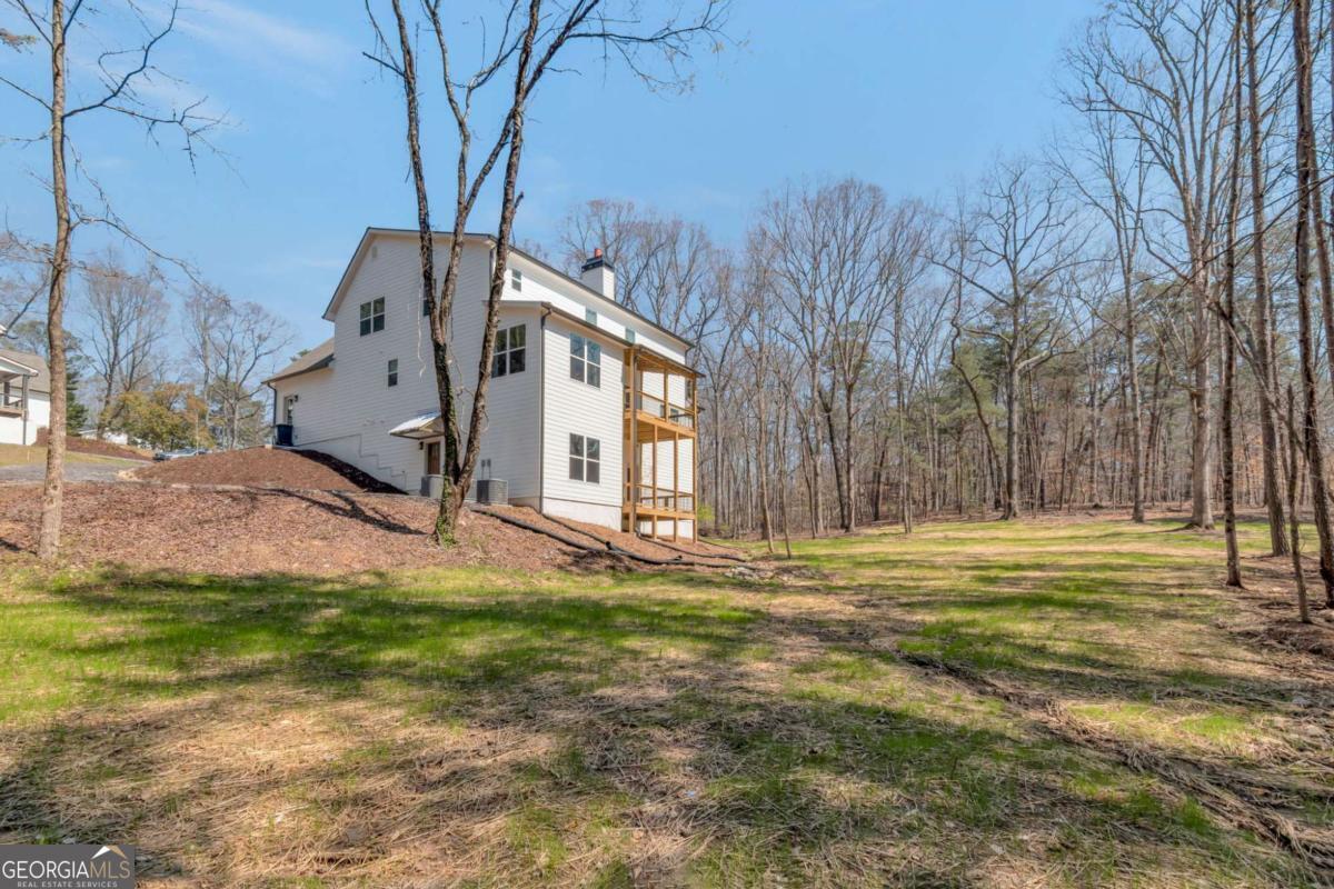629 Butterworth Road Canton, GA 30114 - Photo 26 of 27 a white house that has a tree in front of it