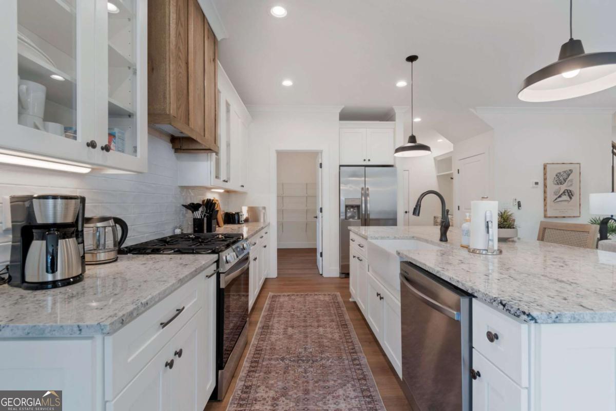 629 Butterworth Road Canton, GA 30114 - Photo 5 of 27 a kitchen with stainless steel appliances granite countertop a sink stove and refrigerator