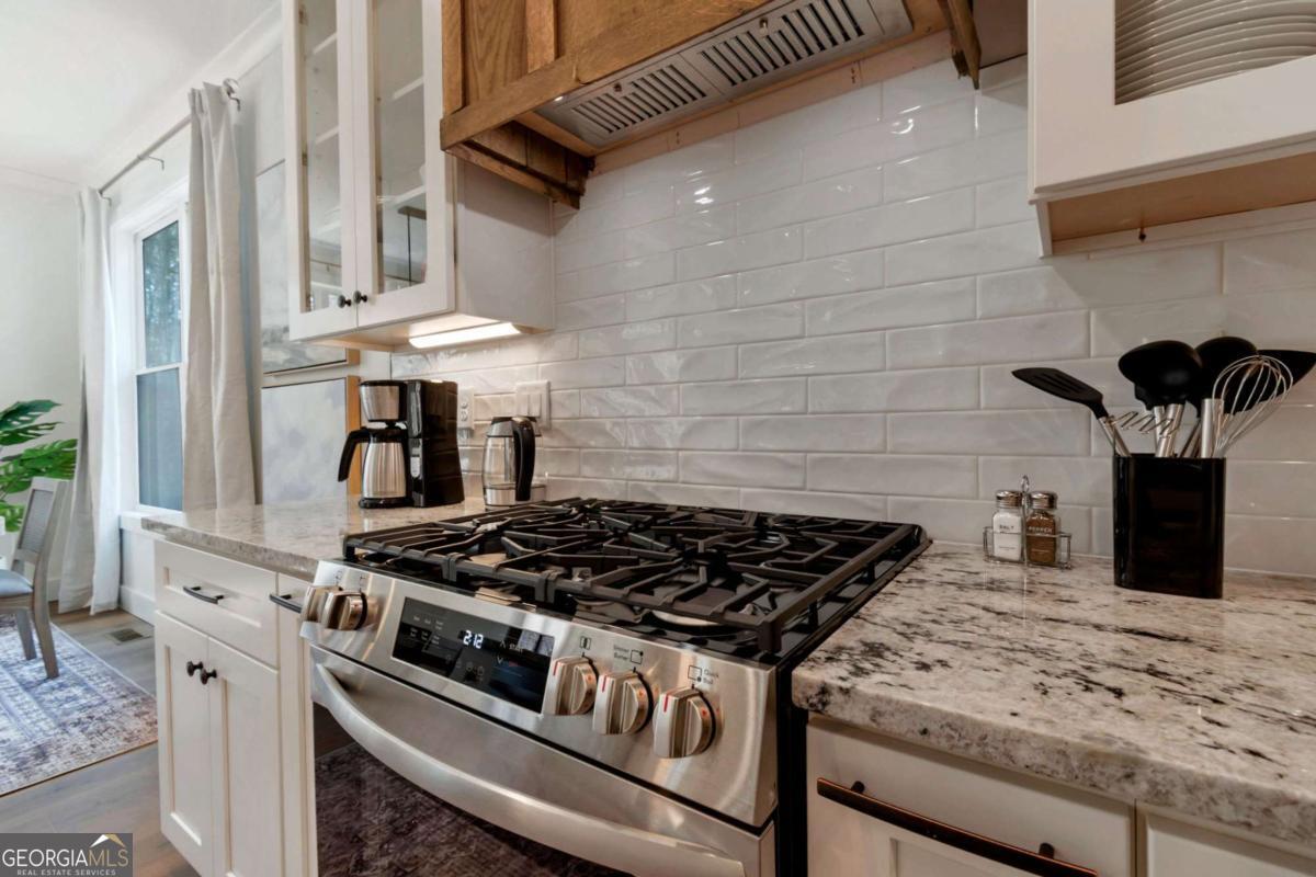 629 Butterworth Road Canton, GA 30114 - Photo 6 of 27 a kitchen with granite countertop a stove and a sink