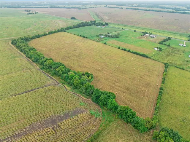 a view of a field with an ocean view