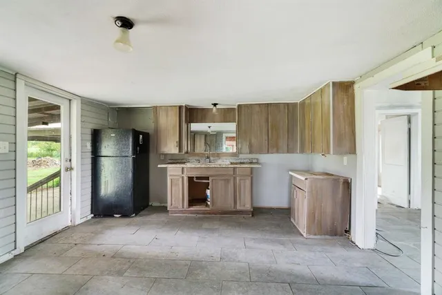 a kitchen with a refrigerator and a sink