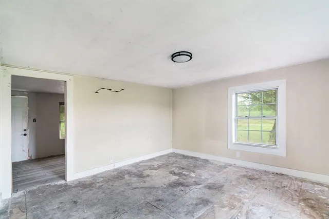 an empty room with windows and closet