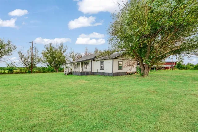a view of a house with a big yard