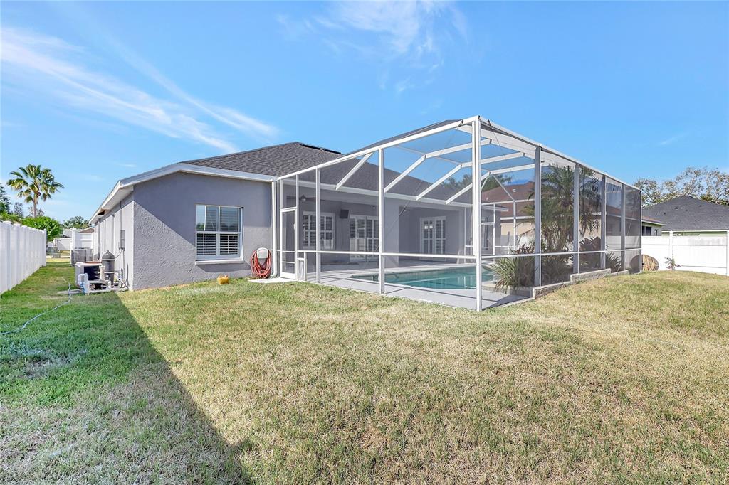 2863 Duncan Tree Circle Valrico, FL 33594 - Photo 7 of 53 a view of a house with a backyard and a garden