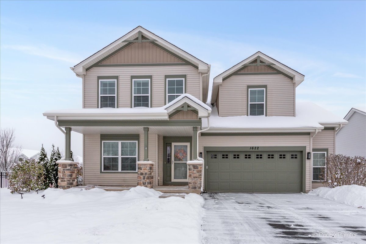 a view of a house with a yard and garage