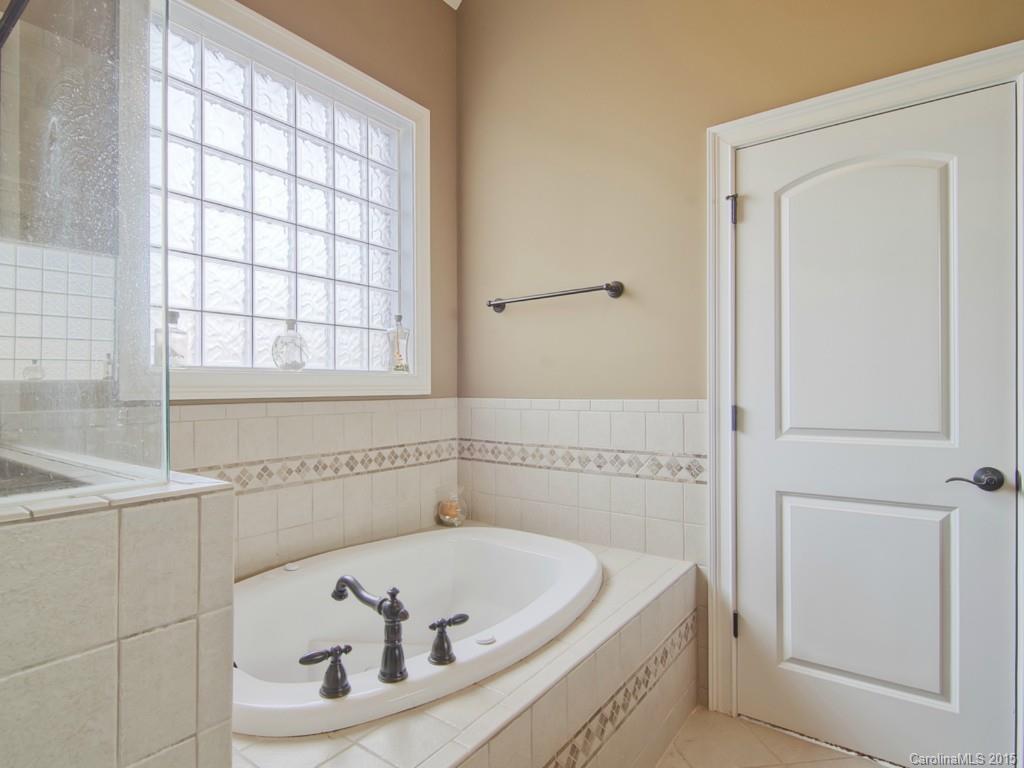 6729 Fox Ridge Circle Davidson, NC 28036 - Photo 12 of 24 a white bath tub sitting in a bathroom next to a window
