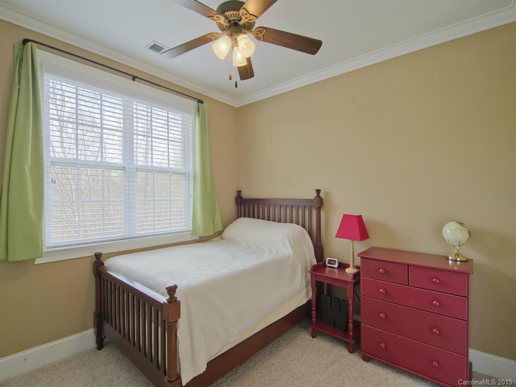 6729 Fox Ridge Circle Davidson, NC 28036 - Photo 14 of 24 a bedroom with a bed and a chandelier fan