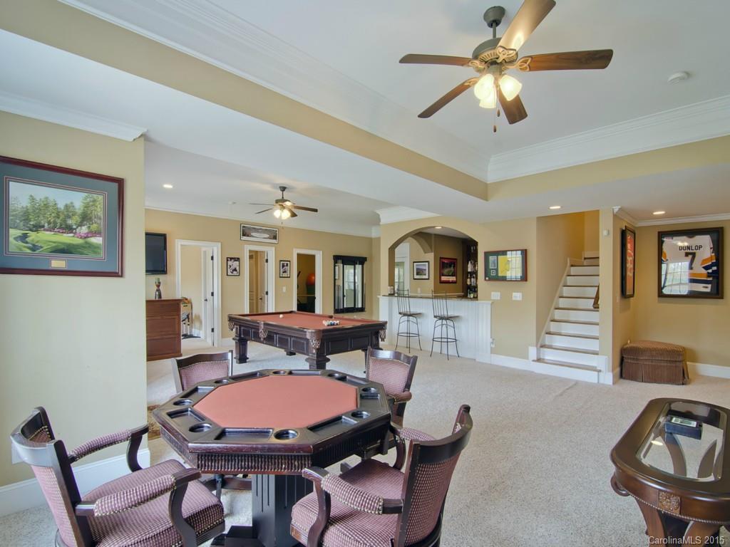 6729 Fox Ridge Circle Davidson, NC 28036 - Photo 16 of 24 a living room with furniture a dining table and a fireplace