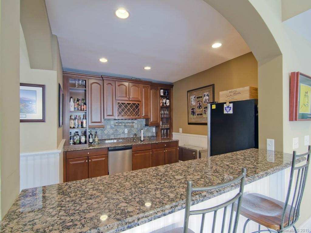 6729 Fox Ridge Circle Davidson, NC 28036 - Photo 18 of 24 a kitchen with stainless steel appliances granite countertop wooden cabinets granite counter tops and a refrigerator