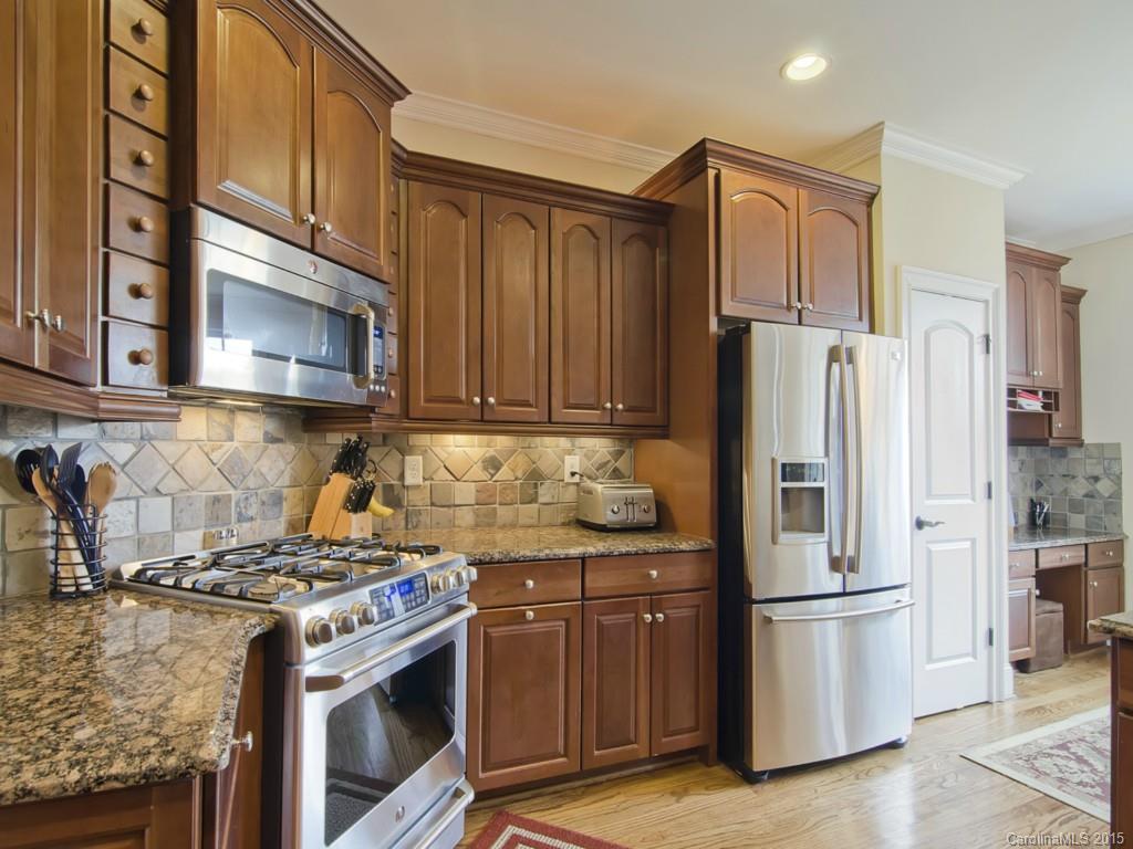6729 Fox Ridge Circle Davidson, NC 28036 - Photo 3 of 24 a kitchen with stainless steel appliances granite countertop a stove a refrigerator and a microwave