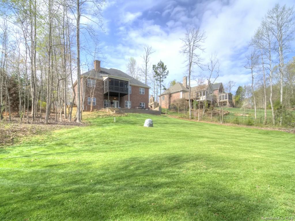 6729 Fox Ridge Circle Davidson, NC 28036 - Photo 23 of 24 a backyard of a house with lots of green space and fountain