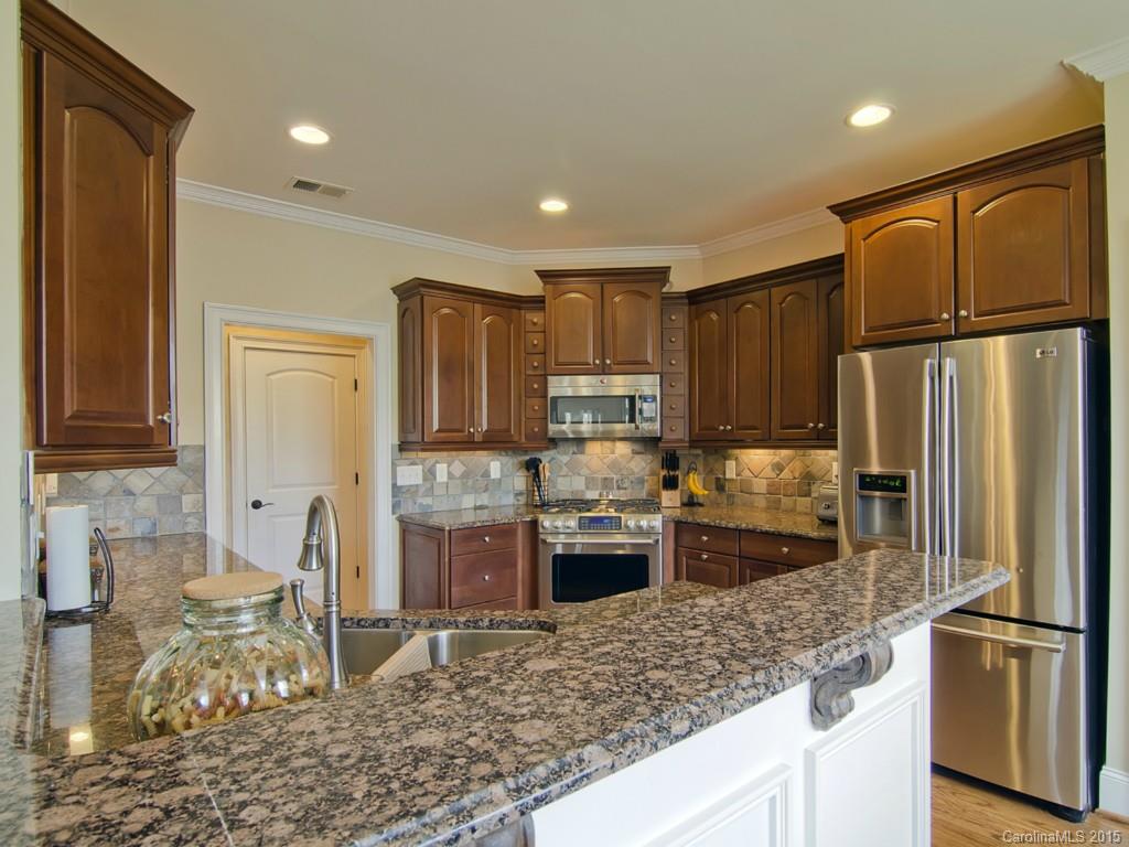 6729 Fox Ridge Circle Davidson, NC 28036 - Photo 5 of 24 a kitchen with stainless steel appliances granite countertop a refrigerator a stove a sink and a microwave
