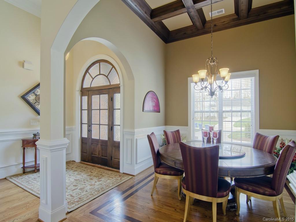 6729 Fox Ridge Circle Davidson, NC 28036 - Photo 7 of 24 a view of a dining room with furniture a chandelier and wooden floor