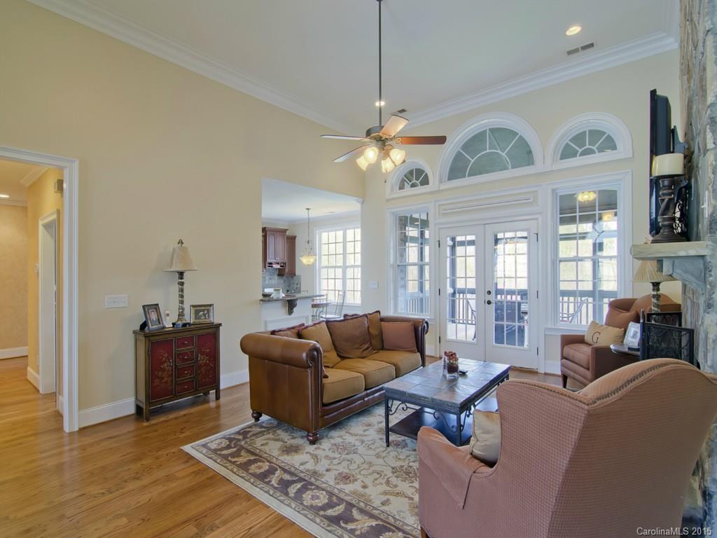 6729 Fox Ridge Circle Davidson, NC 28036 - Photo 8 of 24 a living room with furniture a chandelier and a flat screen tv
