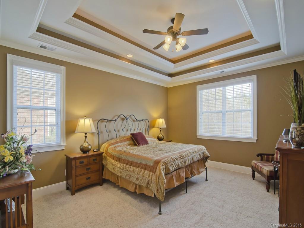 6729 Fox Ridge Circle Davidson, NC 28036 - Photo 10 of 24 a bedroom with a bed a chandelier and a window