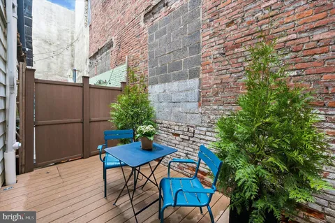 a backyard of a house with table and chairs