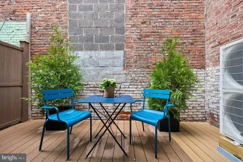 a view of a chairs and table in a patio