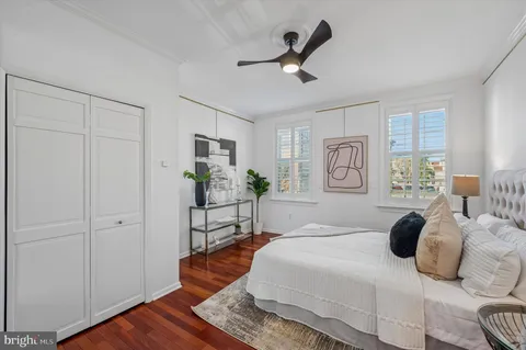a spacious bedroom with a bed and a chandelier