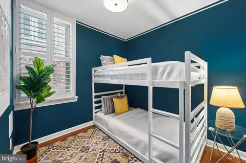 a bed room with a bed and a potted plant