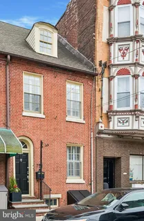 a front view of a house with a parking space