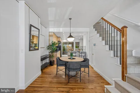 a dining room with furniture a rug and wooden floor