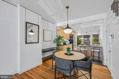 a view of a dining room with furniture window and wooden floor