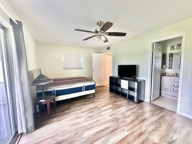 a bedroom with furniture and a flat screen tv