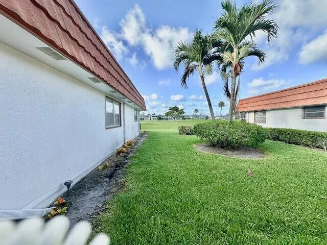 a view of a house with a palm tree