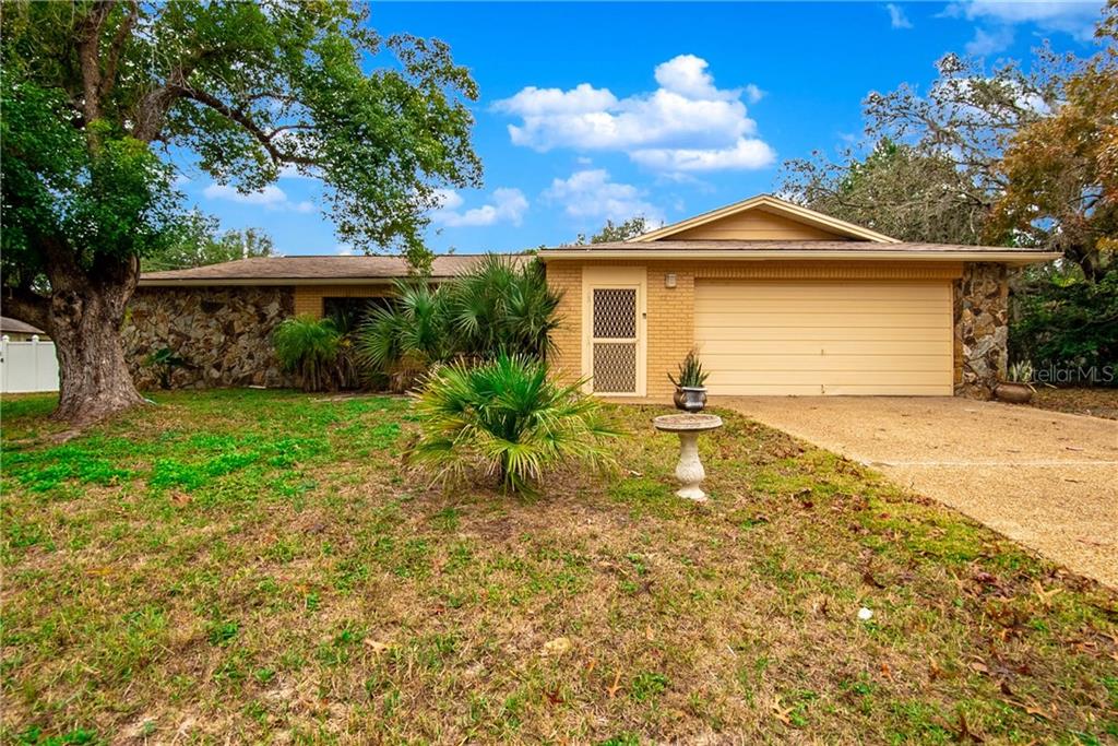 1395 Meadow Lark Road Spring Hill, FL 34608 - Photo 1 of 1 a front view of a house with a yard