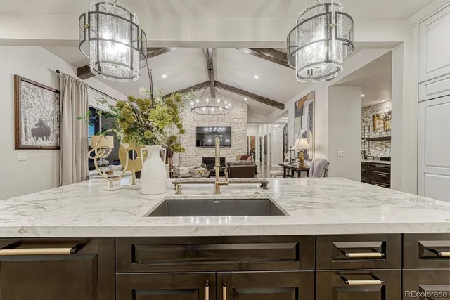 a view of a counter top a dining table and chandelier