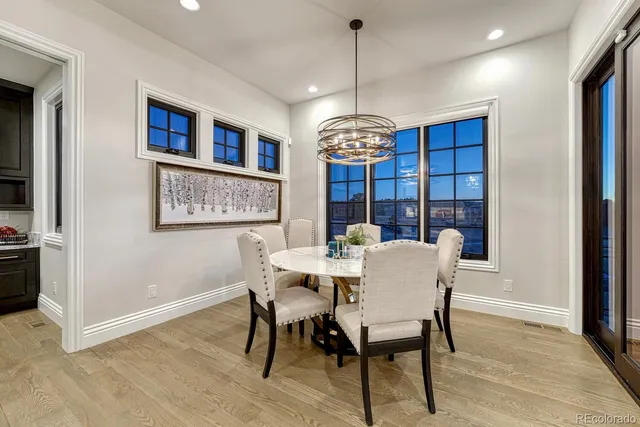 a view of a dining room with furniture wooden floor and chandelier