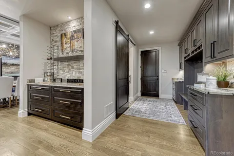 a view of kitchen with stainless steel appliances kitchen island wooden cabinets and stove top oven