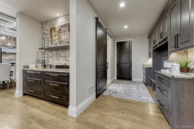 a view of kitchen with stainless steel appliances kitchen island wooden cabinets and stove top oven