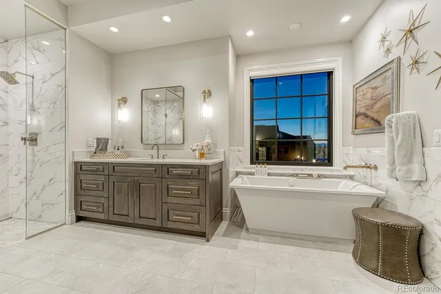 a bathroom with a granite countertop sink a bathtub and a double vanity