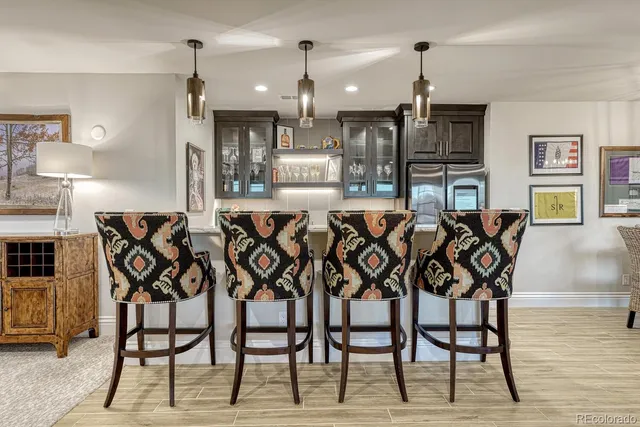 a dining area with furniture and wooden floor