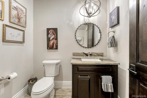 a bathroom with a toilet a sink and a mirror